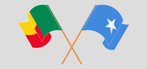 Crossed and waving flags of Benin and Somalia