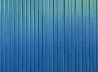 Building wall clad in blue plastic siding