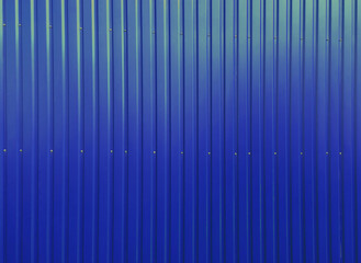  Building wall clad in blue plastic siding