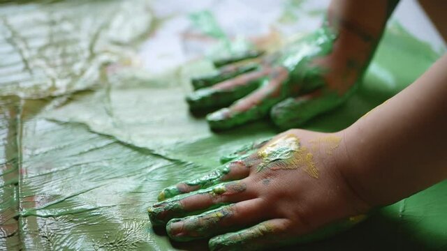 Enfant qui faite de la peinture avec les mains