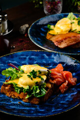 Fresh sandwich with egg poached, red fish on rye bread. Keto-balanced diet food. Healthy and nutritious food