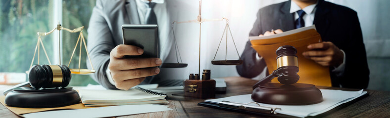 Business and lawyers discussing contract papers with brass scale on desk in office. Law, legal services, advice, justice and law concept