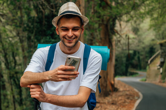 young traveler with mobile phone taking photos