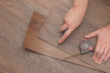 The process of laying vinyl flooring in public places, cutting brown vinyl floors. Resistant floors...