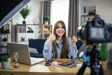 Beautiful young woman taking about skin care treatments while sitting at table with various...
