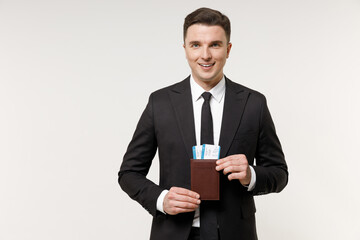 Traveler tourist business man in classic formal black grey suit hold passport tickets isolated on white office background. Passenger traveling abroad on weekends getaway. Air flight journey concept.