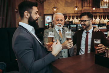  Three business people celebrating successfully done job at restaurant.
