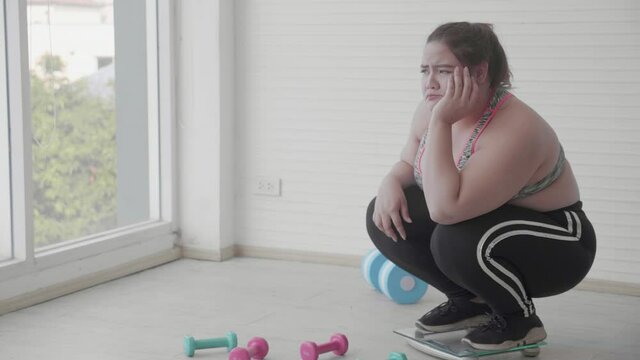 Young woman fat feel upset after measuring scale at home, female with overweight stress and worry while frustrated with weight loss, plus size, obesity and calorie, dieting for control weight.