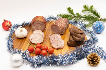 Smoked and baked turkey roll with herbs on a Christmas wooden background.