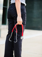 healthcare professional with stethoscope in hand