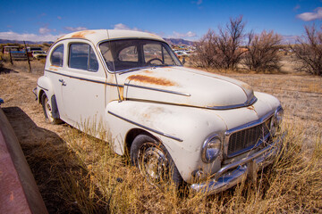 Obraz na płótnie Canvas Exterior of a junked vintage retro vehicle in a junkyard.