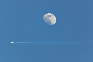 airplane flying close to moon