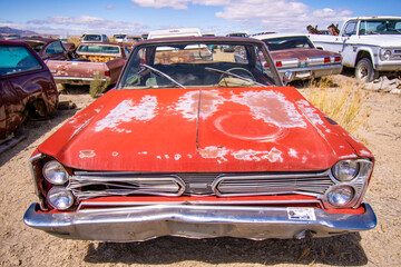 Exterior of a junked vintage retro vehicle in a junkyard.