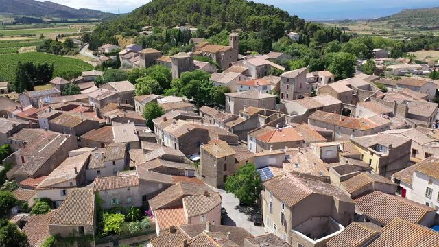 Scenic aerial view of French township of Fontcouverte at foot of Alaric mountain on sunny summer day, Aude, Occitanie