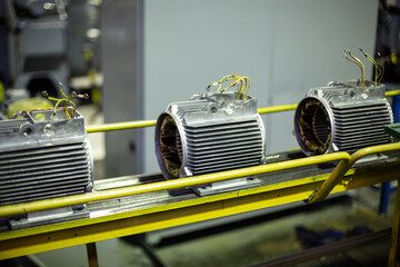 Parts of electric motors on assembly line of Semi-automated manual production. equipment and...