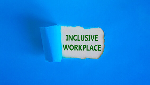 Inclusive Workplace Symbol. Concept Words 'inclusive Workplace' Appearing Behind Torn Blue Paper. Beautiful Background. Business And Better Inclusive Workplace, Better Inclusion Concept. Copy Space.