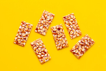 Honey bars with peanuts on yellow background