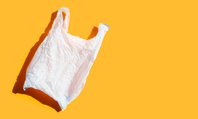 Fototapeta na wymiar White plastic bag on orange background.