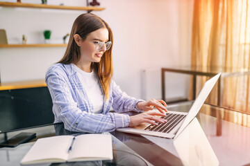 Happy beautiful woman working on laptop at home. Concept for rob