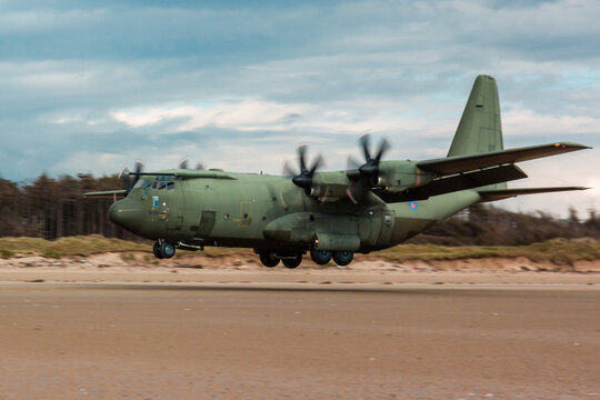 A Royal Air Force C-130 performing tactical landings and takeoffs from the public beach at Cefn Sidan Sands in West Wales.