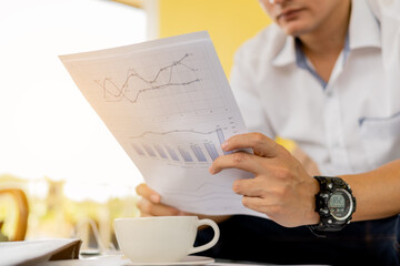 Businessman checking report chart. Businessman analyzing financial report.