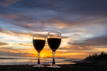 Two Wine Glasses on Hawaii Black Sand Beach honeymoon travel