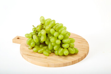 Green grapefruits a wooden cutting board