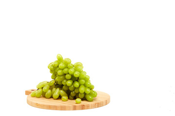 Green grapefruits a wooden cutting board