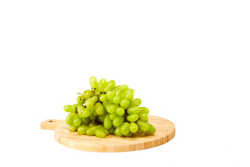 Green grapefruits a wooden cutting board