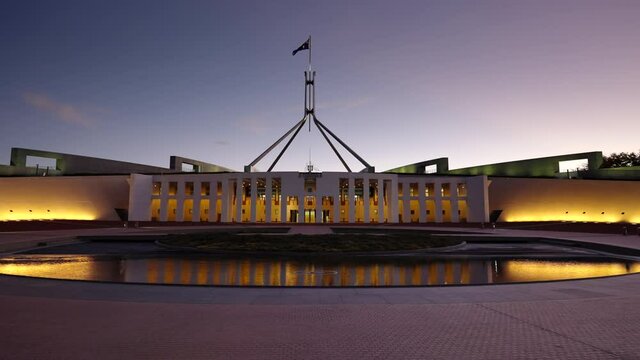 the australian federal parliament house in canberra at dusk