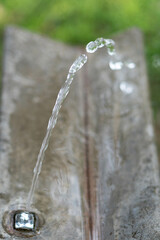 Closeup of the clean fresh water coming from the outdoor water tap © Ariel Russo/Wirestock