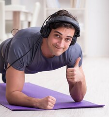 Man doing sports at home and listening to music