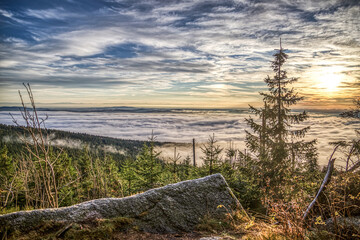 Fototapeta na wymiar foggy view at sundown on mount Dreisessel, a mountain in the bavarian forest