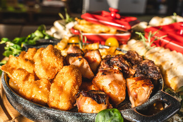 Close up on the plate with fresh roasted barbecue meat chicken bacon rolls and traditional grill