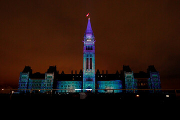 Christmas Lights Across Canada projecting a light show onto the Parliament Buildings of Canada