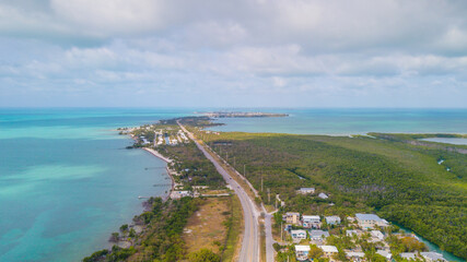 Fototapeta na wymiar Florida Keys. Bridge or road on Key West FL. Atlantic ocean and Gulf of Mexico. Spring break or Summer vacations in Florida. Tropical nature. Aerial view.
