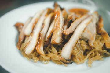 Grilled pork neck place on stir noodles, a popular appetizer in Thailand