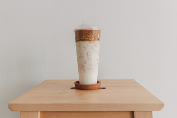 Iced coffee milk served in a tall plastic cup.