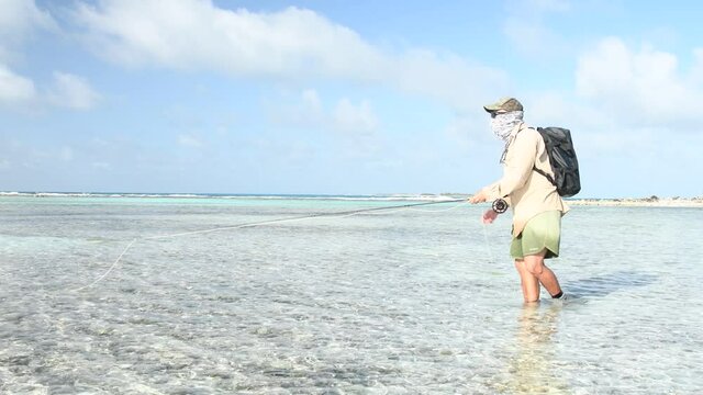 men saltwater  fly fisherman cast front the camera