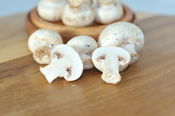 Mushrooms on a wooden chopping board on a white background