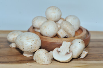 Mushrooms on a wooden chopping board on a white background