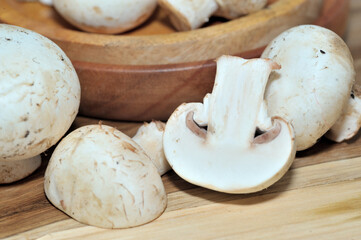 Mushrooms on a wooden chopping board on a white background
