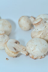 Mushrooms on a wooden chopping board on a white background