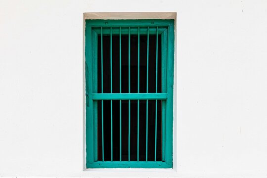 Antique wooden window frames with green bars isolated on a white blackground