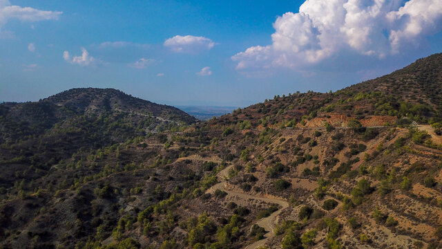 
Aerial view of the rocky hills with road serpentine and the desert area at sunset, Cyprus photo by drone