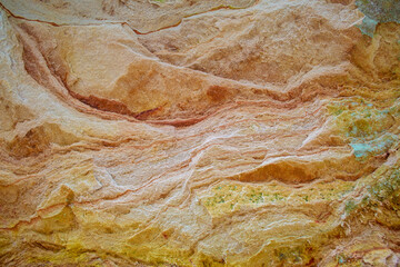 Natural background. Details of beige - yellow sandstone. Close-up texture of sand wall.