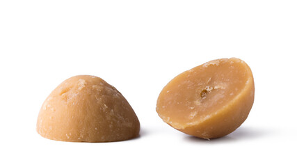 jaggery, golden brown color, cup shaped unrefined sugar product also called kithul jaggery or palm sugar,sweet and sugary traditional food in sri lanka and southeast asia, isolated on white background