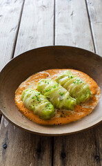 Cabbage rolls stewed with vegetables in tomato sauce