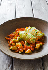 Cabbage rolls stewed with vegetables in tomato sauce