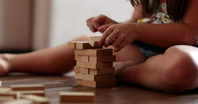 Child playing with wooden building blocks